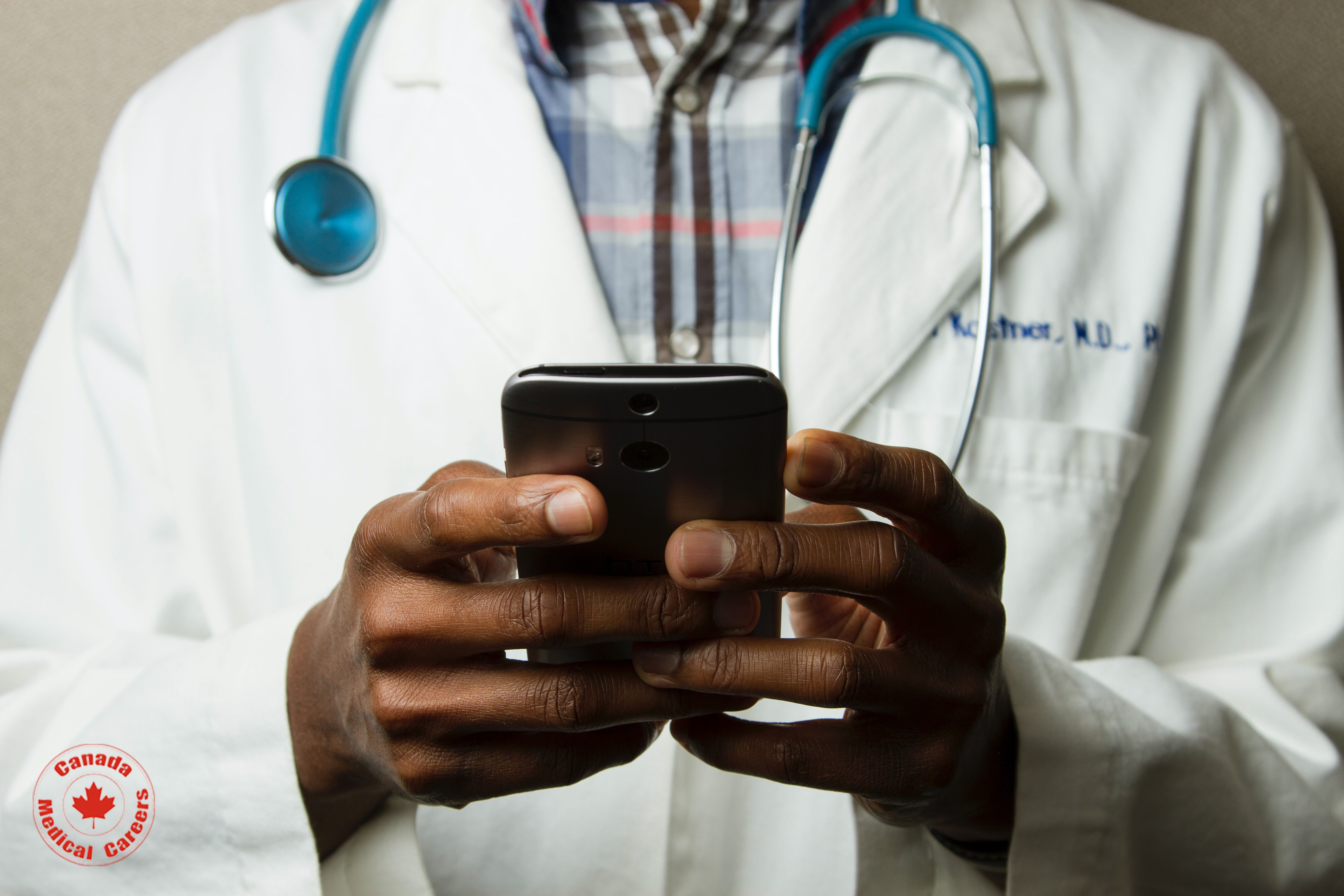 A doctor holding a phone